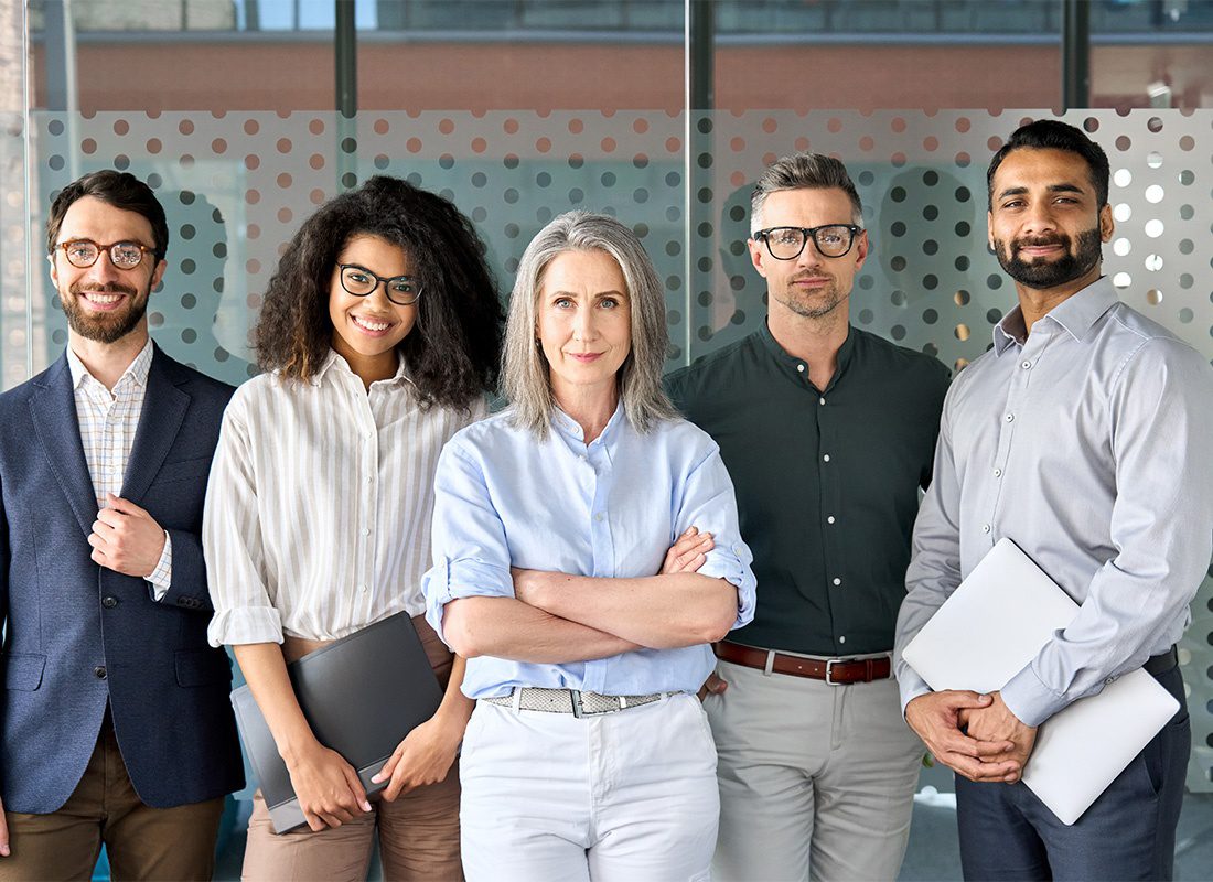 Contact - Group Portrait of a Happy Business Team Standing Together in a Professional Office